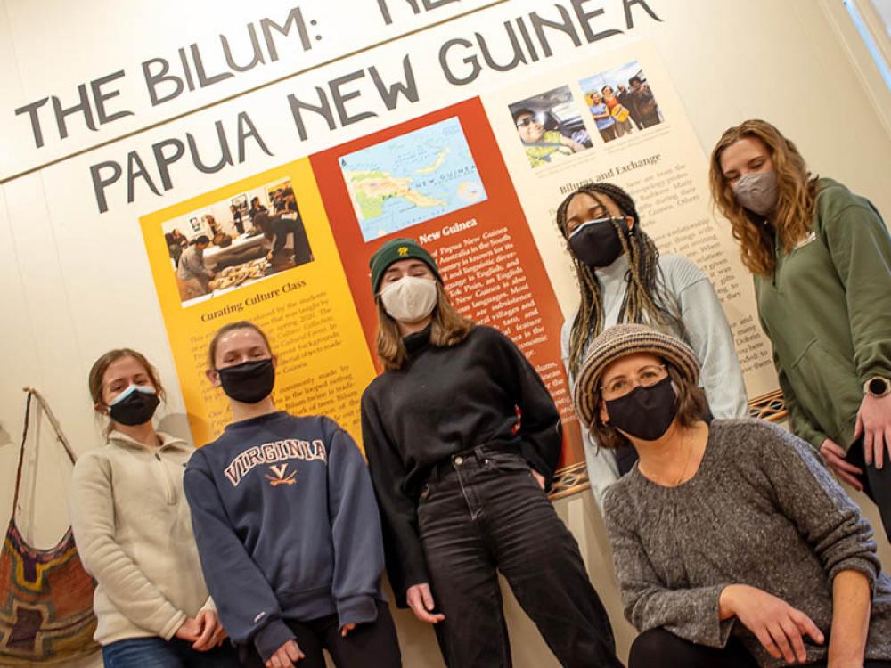 Abby Duff, Alexandra Shaul, Maggie Harris, Lauren Parker, Elli Perkins (left to right, standing) and other students assisted Assoc. Prof. Lise Dobrin (kneeling) to mount the Brooks Hall exhibit based on a spring 2020 anthropology class.