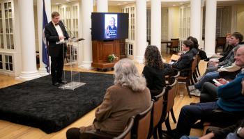 UVA history professor Andrew O'Shaughnessy stands before an audience delivering a history lecture on the founding of the University of Virginia.