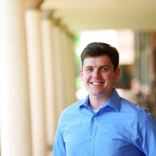 Matt Newton standing by the colonnades flanking the Lawn at the University of Virginia.