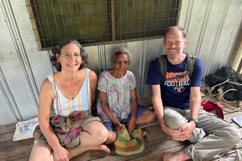 UVA linguist Lise Dobrin and UVA Wise ethnobotanist Ryan Huish flank a village elder, Lusi Taramap, who helped the researchers understand the relationships among banana varieties. (Photo courtesy of Lise Dobrin and Ryan Huish)