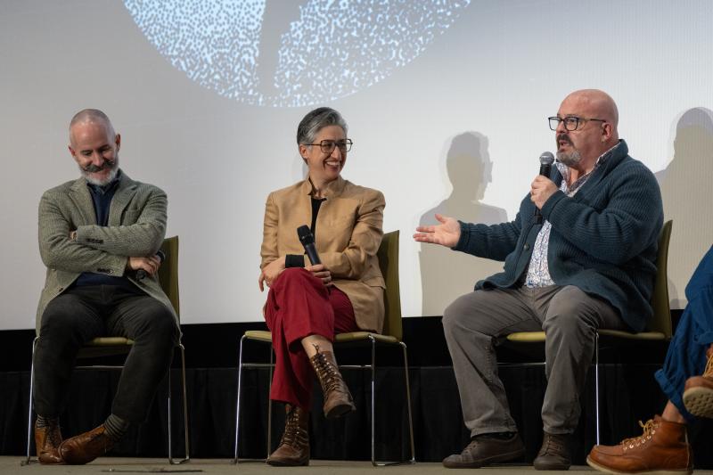 Three A&S faculty members sit on stage in discussion at the Global Spanish Initiative's closing event.