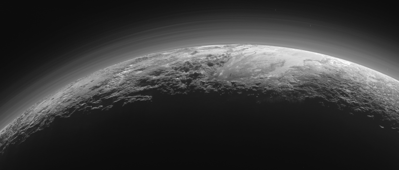A photo taken just 15 minutes after its closest approach to Pluto on July 14 as New Horizons looked back toward the sun, shows the deep haze layers of Pluto’s atmosphere and rugged mountains up to 11,000 feet high.