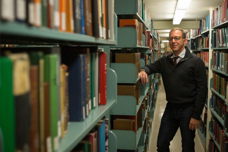 Associate Professor of English Andrew Stauffer in the Alderman Library stacks.