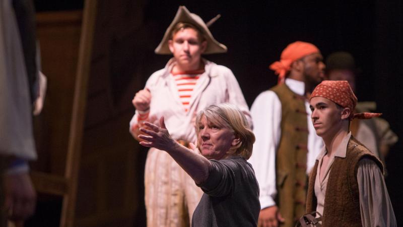 Director Colleen Kelly, serving as the festival’s interim artistic director after longtime director Robert Chapel retired last year, advises actors during the dress rehearsal for the comedic opera “The Pirates of Penzance.”