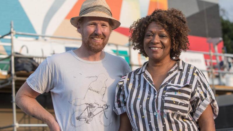 Dove, pictured with Guinn, said that murals, like poetry, can make viewers pause and take stock of the world around them.