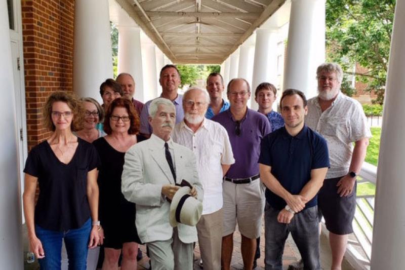 A dozen members of the team that includes more than 35 scholars and technology experts met on Grounds recently to talk about the digital project. Note the Faulkner cutout in their midst.