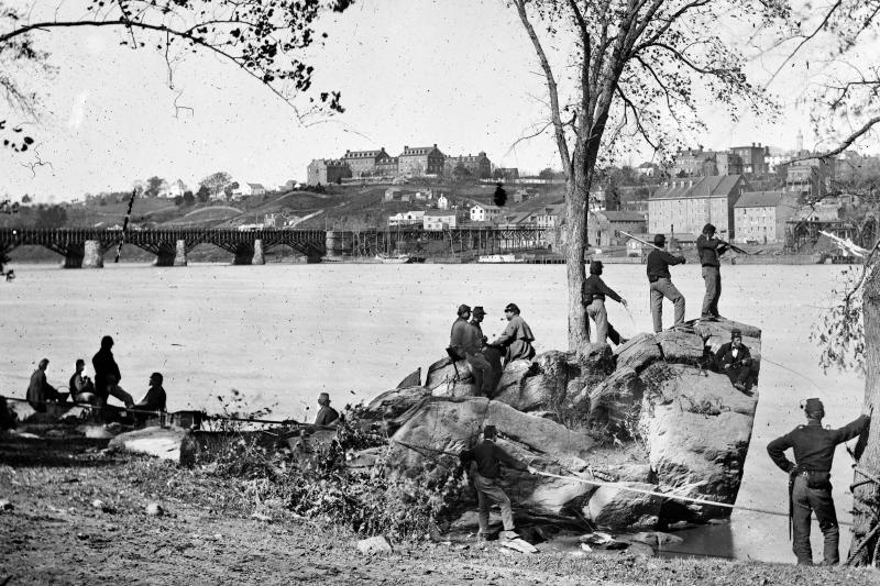 Union soldiers on Mason’s Island, which served as a training camp, in Washington in 1861. Across from them is the Potomac Aqueduct Bridge;