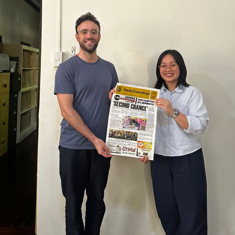 Spanish Ph.D. student Robert Sanchis-Álvarez and Center for West Visayan Studies director Frances Anthea R. Redison pose with the morning's edition of the Daily Gua