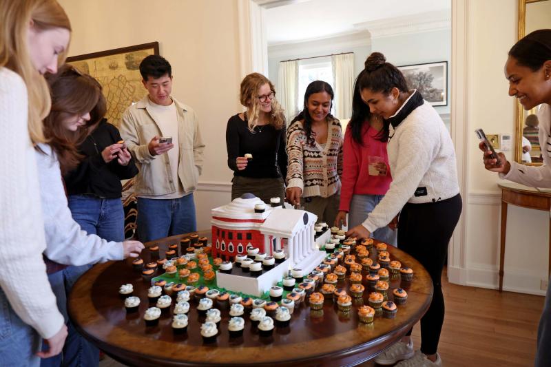 Students celebrating with a Rotunda cake and cupcakes on Carr's Hill